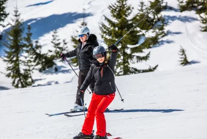 Twee skiërs op een besneeuwde piste in de bergen.