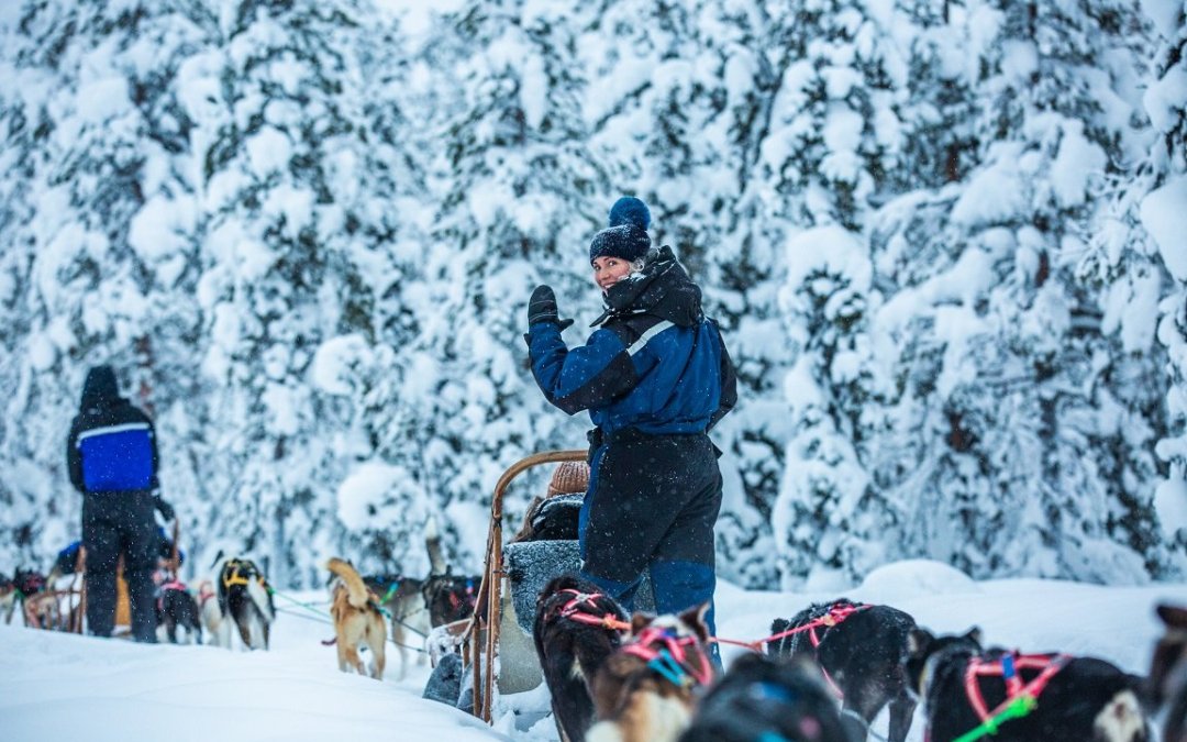 Reisgenoot tijdens de husky-safari in de besneeuwde omgeving.